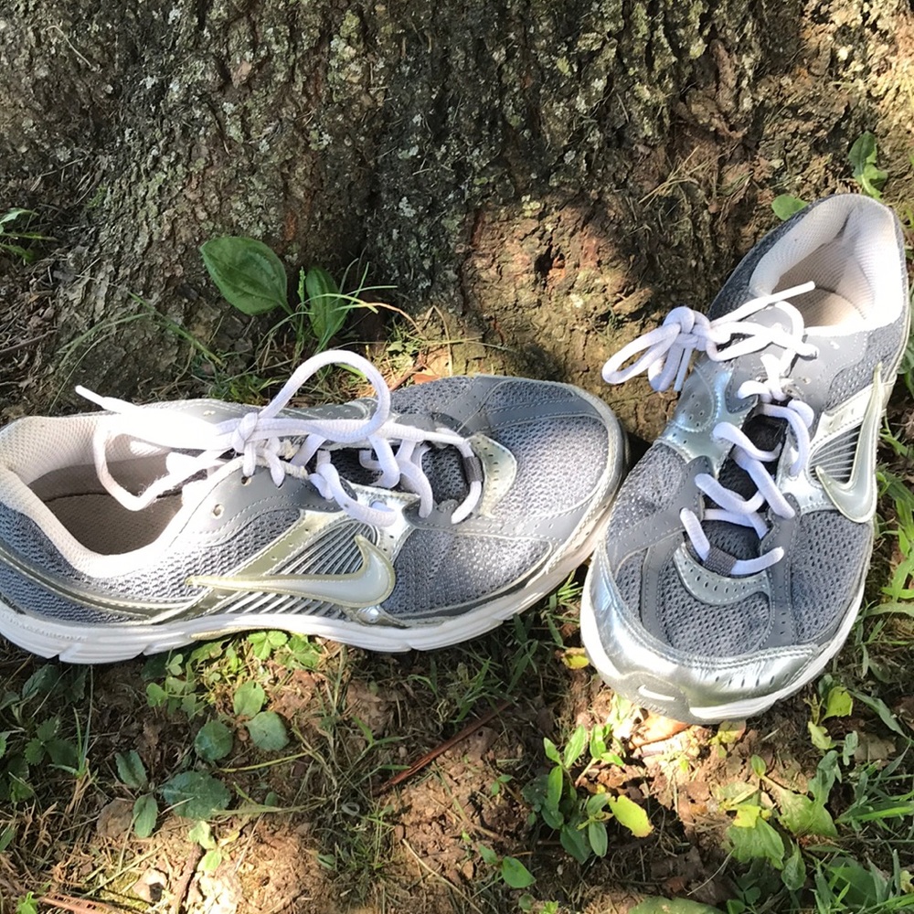 Silver Nike running shoes.